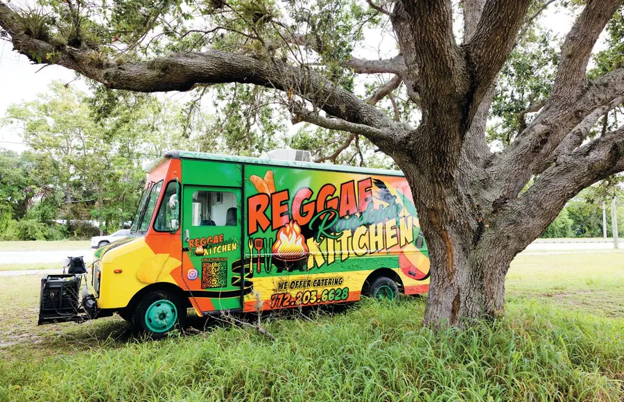 The Reggae Roadside Kitchen food truck under a tree